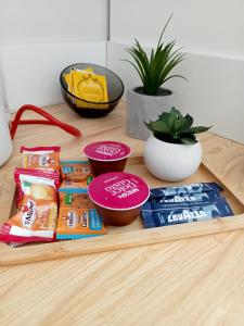 a wooden table with snacks and bowls on it at Nancy Ville in Nancy