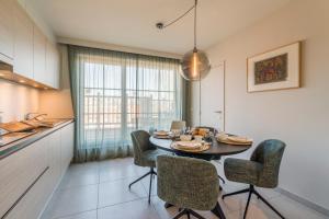 a kitchen and dining room with a table and chairs at Smeysea - Stylish apartment in Sint-Idesbald in Sint-Idesbald
