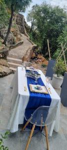 a white table with a blue table cloth and a chair at The Throne in Johannesburg