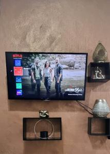a flat screen tv hanging on a wall at The Throne in Johannesburg