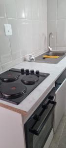 uma cozinha com um fogão e um lavatório em The Throne em Joanesburgo