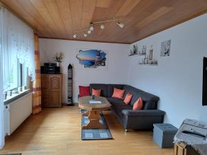 sala de estar con sofá y mesa en Ferienwohnung Wiesengrund, en Hahnstätten