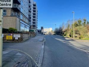 an empty street in a city with a building at Basingstoke by train station in Basingstoke