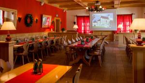 a dining room with tables and chairs and a screen at Hotel Zamek Bobolice in Bobolice