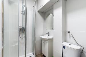 a bathroom with a shower and a toilet and a sink at Niepodleglosci Studio in Sopot