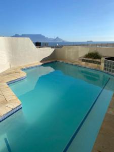 a large swimming pool with blue water at Bali in Blouberg in Cape Town