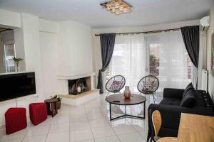 a living room with a couch and a fireplace at Lavrio Seaview 2bdr Apt 4 min dive from the sea in Lávrion