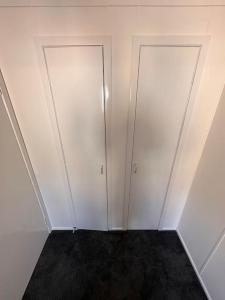 an empty room with two doors on the wall at Semi-detached chalet at Maryville Caravan Site - Uddingston, Glasgow in Uddingston +11 photos