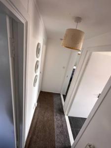 a room with a hallway with a door and a mirror at Semi-detached chalet - Uddingston, Glasgow in Uddingston