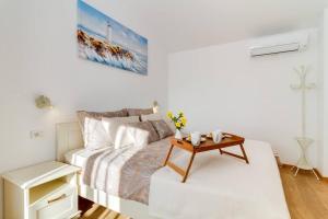 a white bedroom with a bed and a table at Villa NIMA - Holiday house with private pool in Barban +34 photos