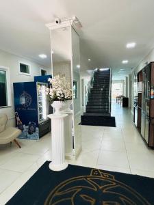 a lobby with a staircase and a vase of flowers at Hotel Antiga Roma in Belém +20 photos