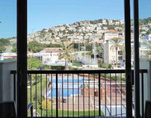 a view of a swimming pool from a window at Estela Barcelona in Sitges