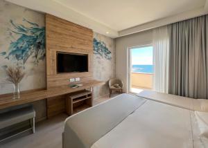a hotel room with a large bed and a television at Hotel Rex in Livorno