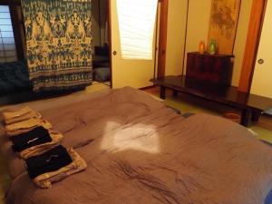Ein Bett oder Betten in einem Zimmer der Unterkunft sabouしが