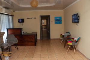 a living room with a table and chairs in a room at The Hill Bed and Breakfast in Francistown
