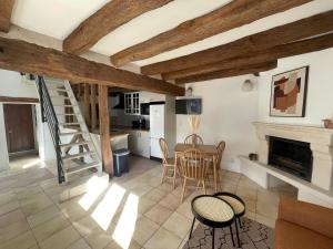 a kitchen and living room with a table and chairs at Le Relai de Boissée in Blois