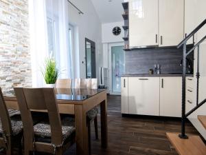 a kitchen and dining room with a table and chairs at Apartments Hera in Mošćenička Draga