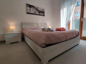 a bedroom with a bed with two pillows on it at Casa Vacanze Calzà in Arco