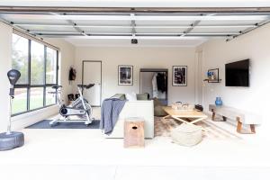 a living room with a bed and a treadmill at River Run Bright in Bright