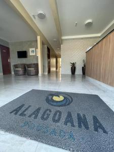 a hotel lobby with a welcome mat on the floor at Hotel Pousada Alagoana in Maceió