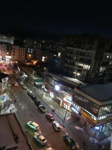 a city at night with cars parked on a street at Центр. Шептицького in Ternopil