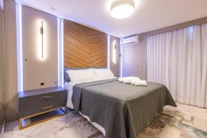 En eller flere senger på et rom på Delupo Apart Hotel