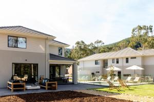 a modern house with a patio and backyard at River Run Bright in Bright