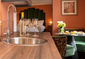 a kitchen with a sink and wine glasses on a counter at The Fanny Talbot in Barmouth