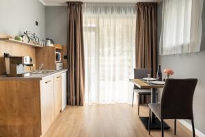 a kitchen and dining room with a table and a window at Villa Pino in Velingrad