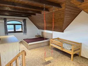 a room with two beds in a attic at Penzion - Apartman Přestavlky in Tršice +45 photos