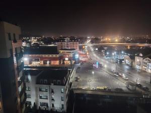 a city at night with a street and buildings at Bya Concept in Iaşi
