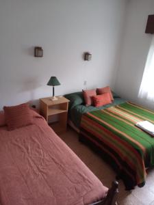 Una cama o camas en una habitación de Córdoba - La Cumbre -Casa Temporario -Vista Cristo