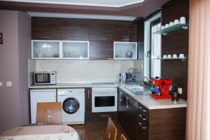 a kitchen with a washing machine and a washer and dryer at Apartment Ira in Velingrad