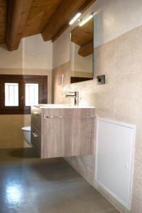 a bathroom with a sink and a toilet at Residence Porta Della Muda in Vittorio Veneto