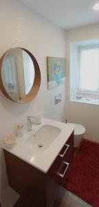 a bathroom with a sink and a mirror at Casa do Avô Horácio in Carreço