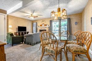 a dining room with a table and chairs and a living room at Snowflakes to Summer Wind in Lake Harmony