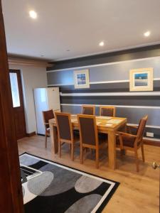 a dining room with a wooden table and chairs at Quiet 3 bed close to the A1 in Newton Aycliffe