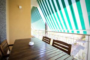 a wooden table with two chairs and a large window at Mediterraneo in Bordighera