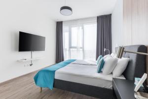 a hotel room with a bed and a tv at Revelton Apartment One Residence in Dubai