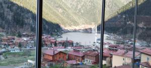 a view of a town and a river from a window at Helen Suit in Çaykara