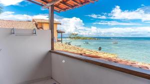 a view of the ocean from the balcony of a house at Pousada Gute Morro in Morro de São Paulo