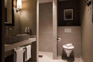 a bathroom with a toilet and a sink at Frösåker G&CC in Västerås