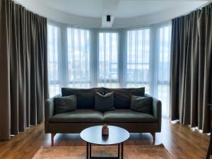 a living room with a couch and a table at Swiss Apartments Prishtina in Pristina