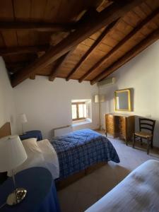 a bedroom with two beds and a table and a chair at La Casina in Siculiana