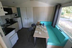 a small room with a table and chairs and a window at Loggia Camping Belle-Vue 2000 in Berdorf