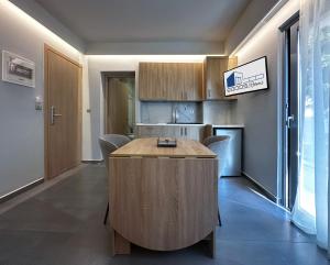 a kitchen with a wooden island in a room at Rodosrooms in Rhodes Town