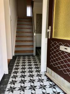 a hallway with a door and a checkered floor at Villa Rosa in Bad Rodach