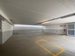 an empty parking garage with yellow lines on the floor at HotelLuxuryPrato in Prato