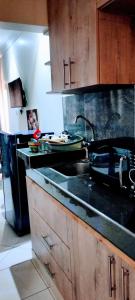 a kitchen with a sink and a counter top at Khalisee Homes Studio Apartment 2 in Voi