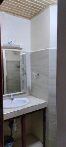 a bathroom with a sink and a mirror at Khalisee Homes Studio Apartment 2 in Voi